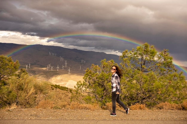 Woman of about 40 years happy to contemplate rainbow