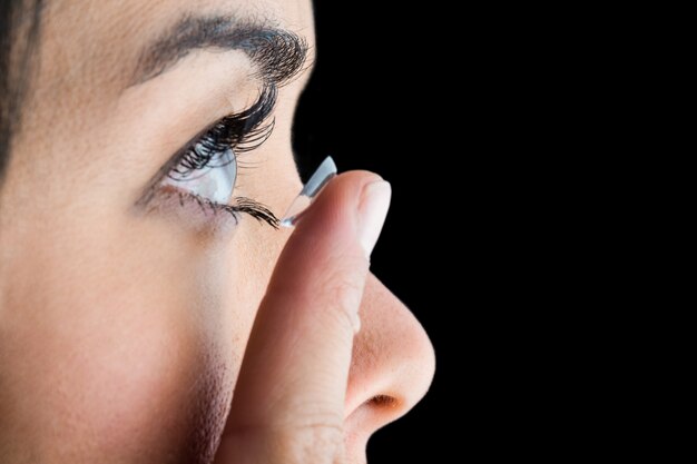 Woman about to insert her contact lens