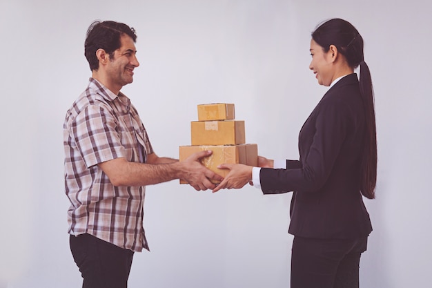 Woman accepting receive a delivery of boxes from delivery asian man