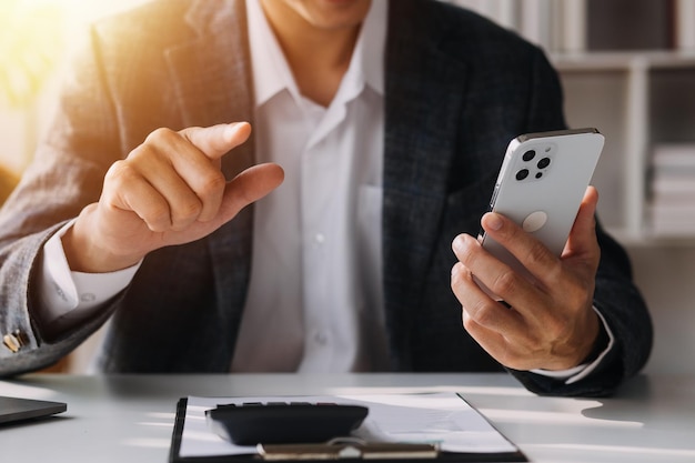 Woman accountant use calculator and computer with holding pen on