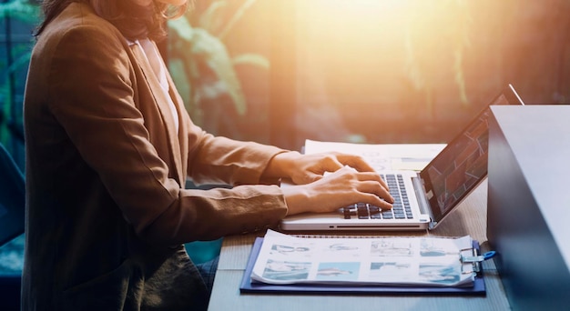 Woman accountant use calculator and computer with holding pen on