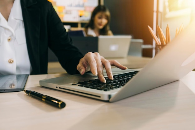 Woman accountant use calculator and computer with holding pen on