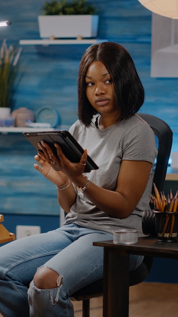 Woman of african american ethnicity holding digital tablet