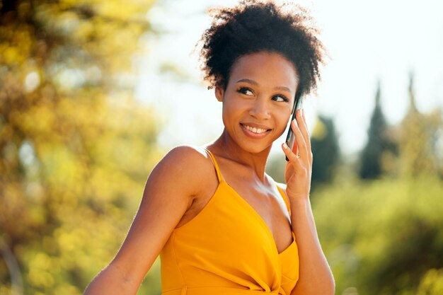 A woman of AfricanAmerican appearance taking a lunch break walks in the park