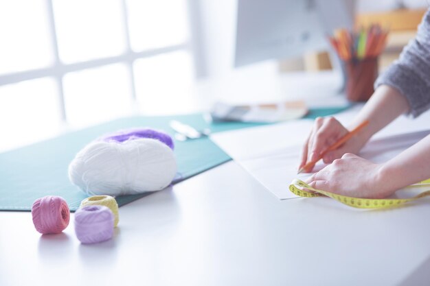 Woman American fashion designer working in atelier