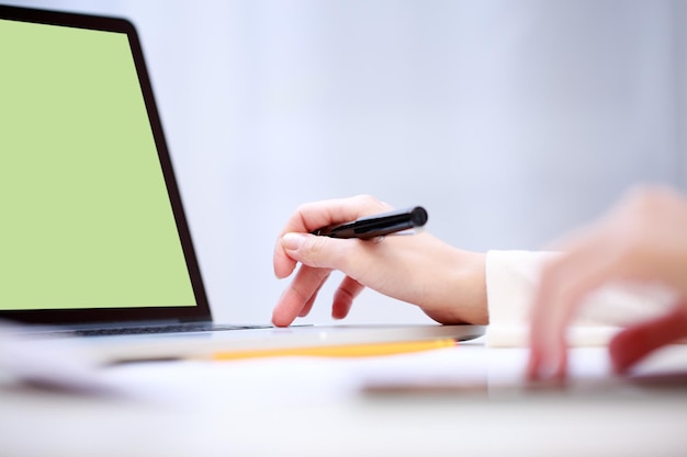 Woman analyzing something at laptop