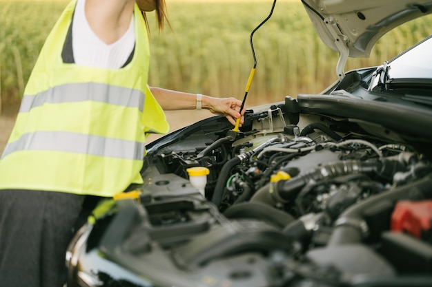 Woman anchoring the hood rod in its groove