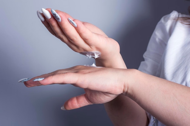 Woman applied moisturizer on her hands