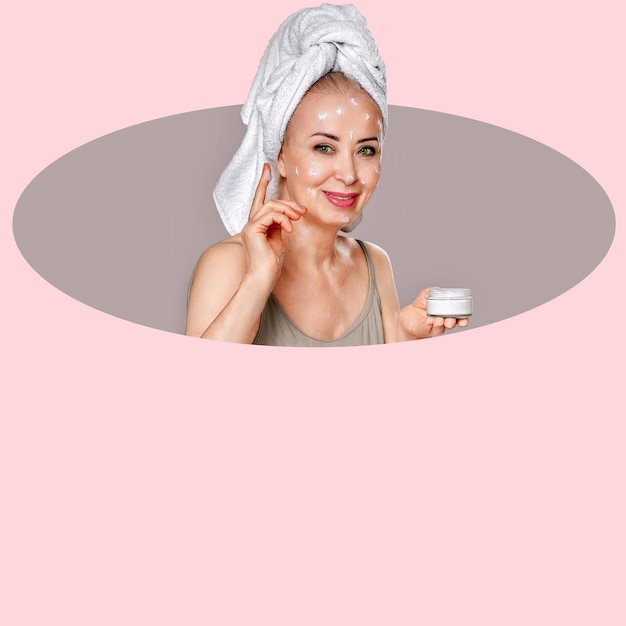 a woman applies cream on her face and neck