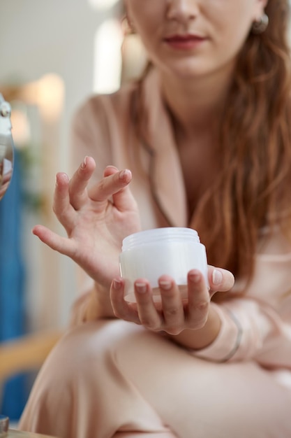 Woman Applying Brightening Moisturizer