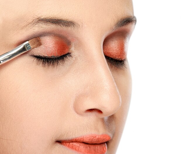 Woman applying eye shadows