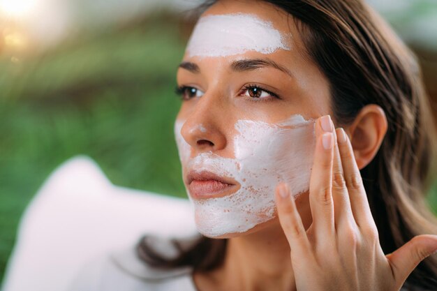 Woman Applying Face Mask at Home