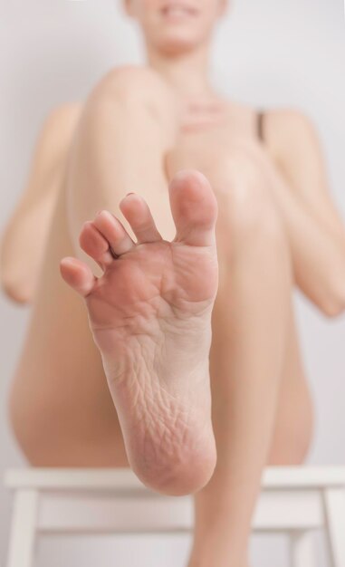 Woman applying foot cream. Spa treatment