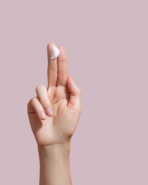 Woman applying hand cream Copy space