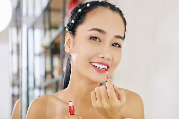 Woman applying liquid lipstick