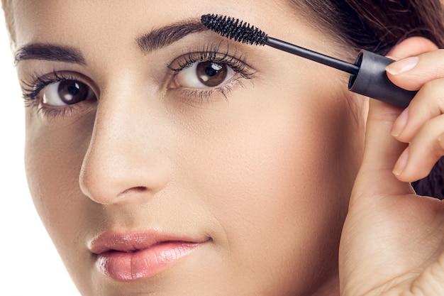 Woman applying mascara 