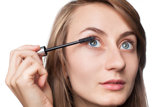 Woman applying mascara