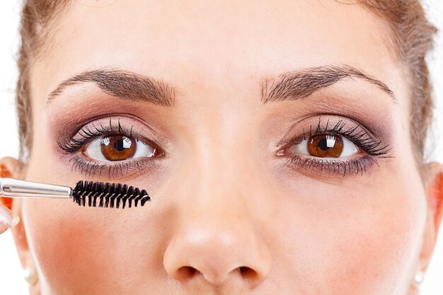 Woman applying mascara