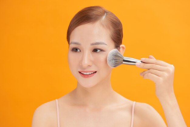 Woman applying powder to clean her face skin.