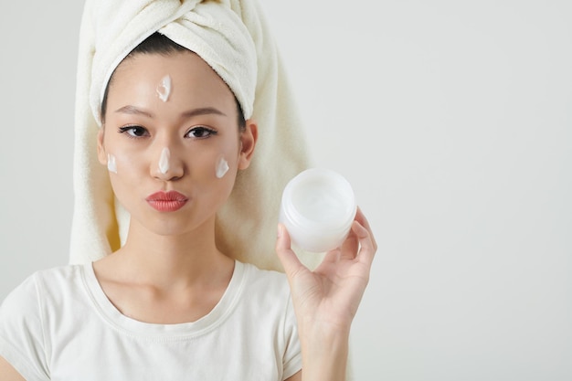 Woman Applying Rich Moisturizer