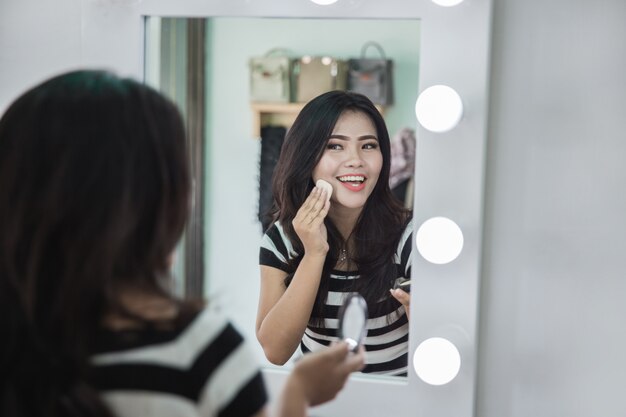 Woman applying some makeup powder