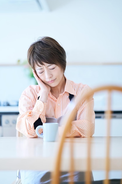 A woman in an apron with a stressed expression