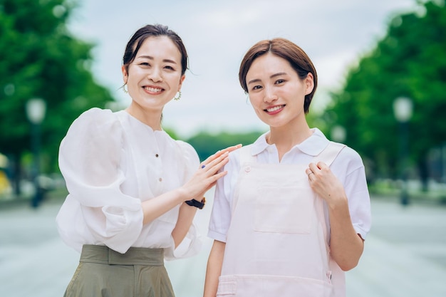 A woman in an apron and a woman in plain clothes