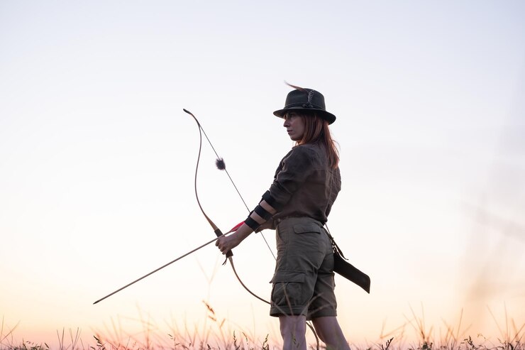 Photo woman archer in sunset