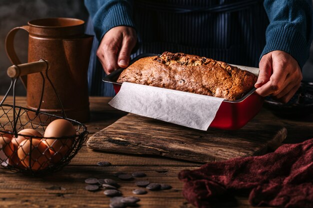 Woman arranging form of bread on table