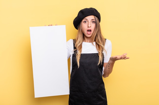 Woman artist amazed, shocked and astonished with an unbelievable surprise empty canvas concept