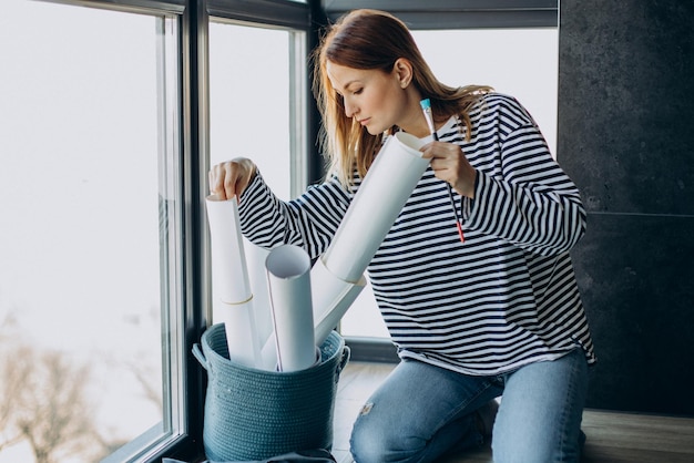 Woman artist painting a picture at home