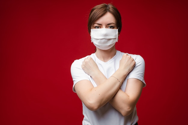 Woman in aseptic mask with crossed arms on her chest
