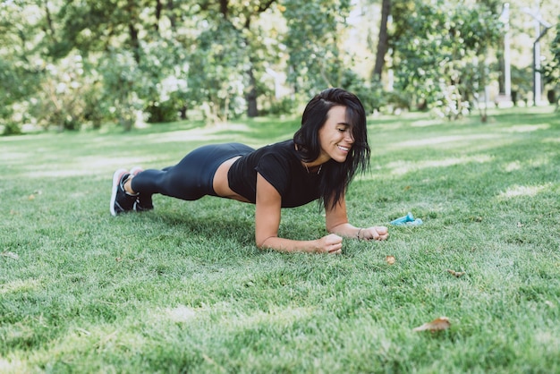 Woman athlete trains in the park