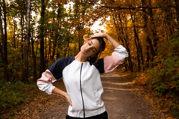 Woman athlete warming up neck before workout