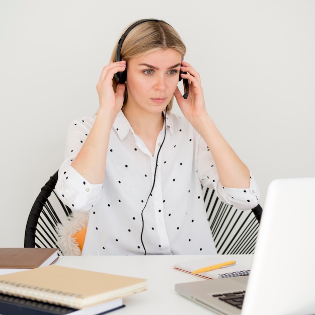 Photo woman attending online courses using headphones