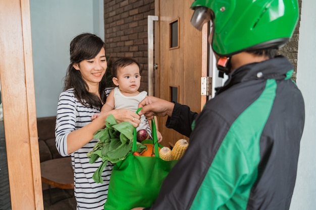 Woman and baby shopping grocery online