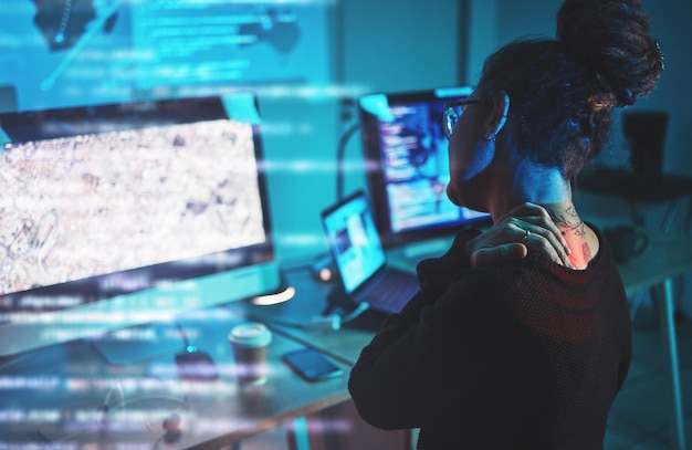 Woman back pain and computer engineering software development or cybersecurity at night stress and pain Fatigue spine problem and tired IT person on monitor in coding or data overlay and graphic