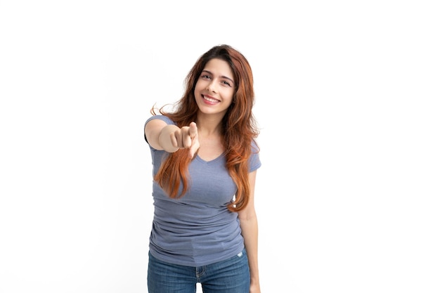 Woman on background pointing fingers towards camera