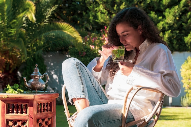 Woman in the backyard using smartphone