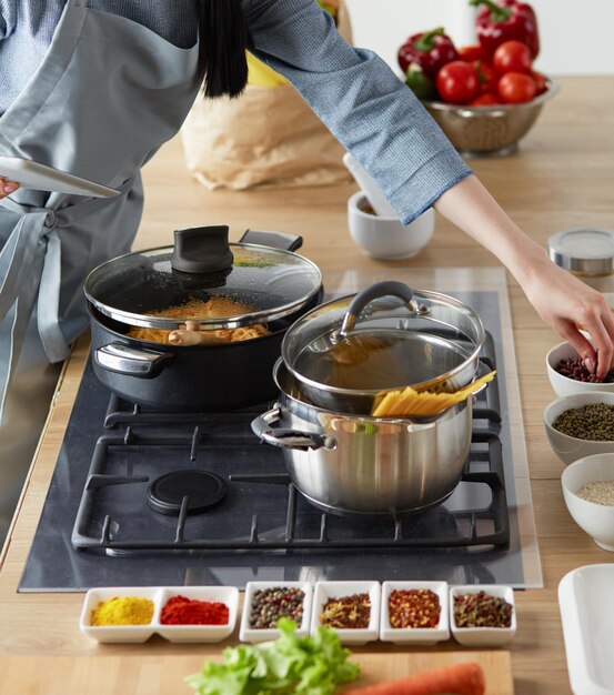 Woman baking at home following recipe on a tablet