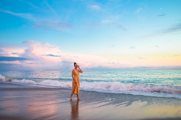 Woman on the beach enjoying summer holidays