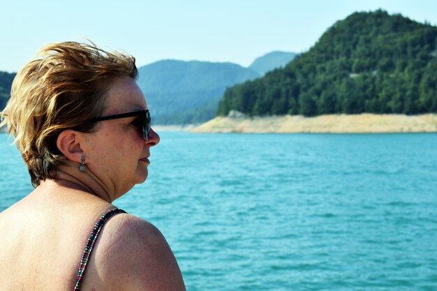 A woman on the beach looks at the sea