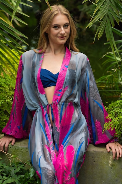 Woman in beachwear tunic resting on tropical resort