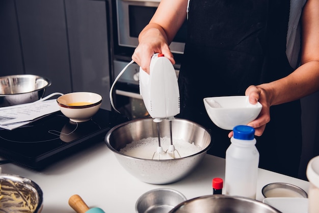 Woman beat dough mixer by machine i