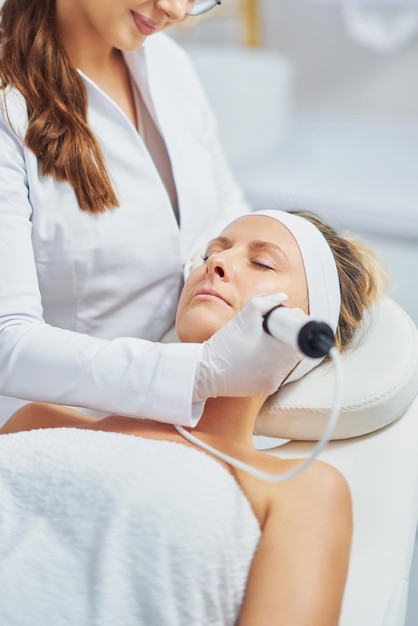 Woman in a beauty salon having face and body treatment