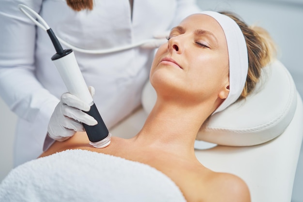 Woman in a beauty salon having face and body treatment