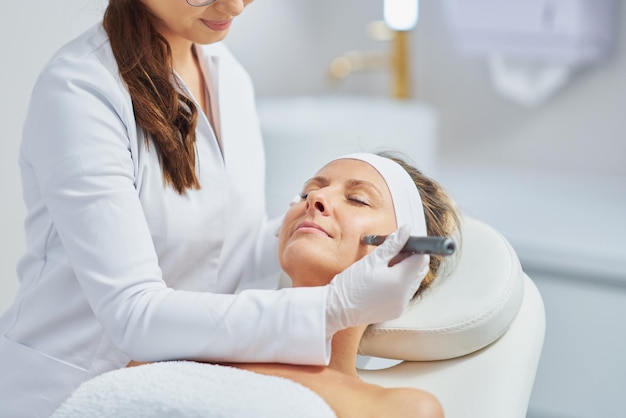 Woman in a beauty salon having needle mesotherapy treatment