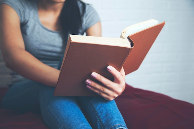 Woman on the bed with hand book