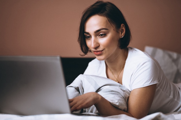 Woman in bed with laptop