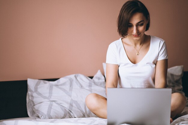 Woman in bed with laptop